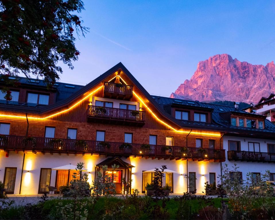 a hotel with a mountain in the background at Residence Langes in San Martino di Castrozza