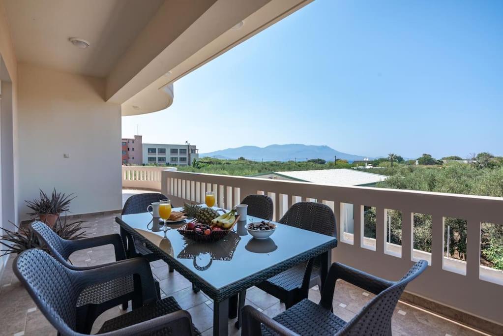 a table with a bowl of fruit on a balcony at Tonia's Residential Villa in Kissamos