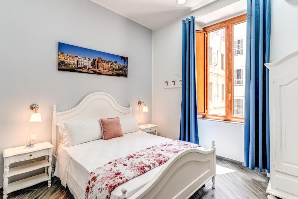 a bedroom with a white bed and a window at Agorà Borsa in Naples