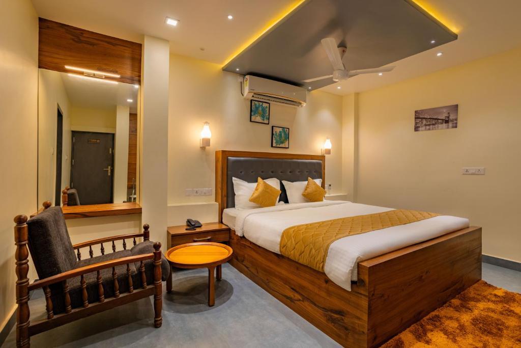 Habitación de hotel con cama y silla en MERIDIAN BY Daan, en Trivandrum