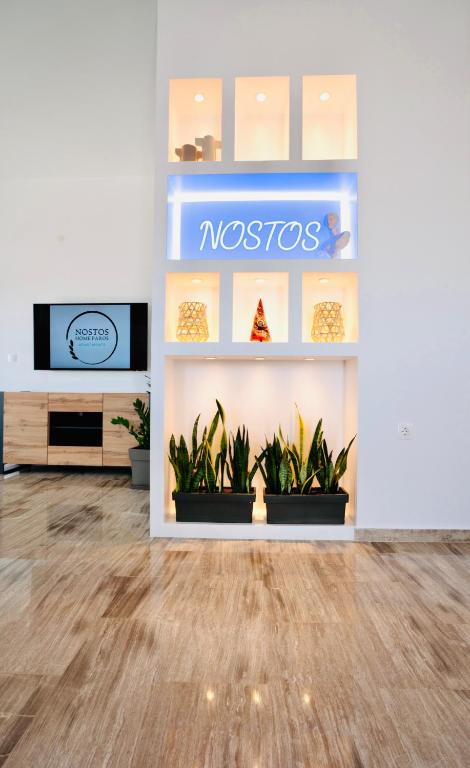 a store with a nostos sign on a wall with plants at Villa Nostos in Dhragoulás