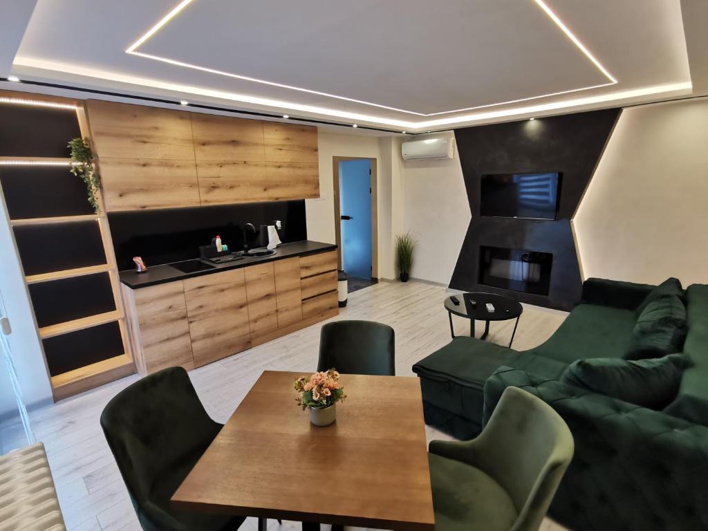 a living room with a couch and a table at Princ Lux Spa with free parking in Novi Sad