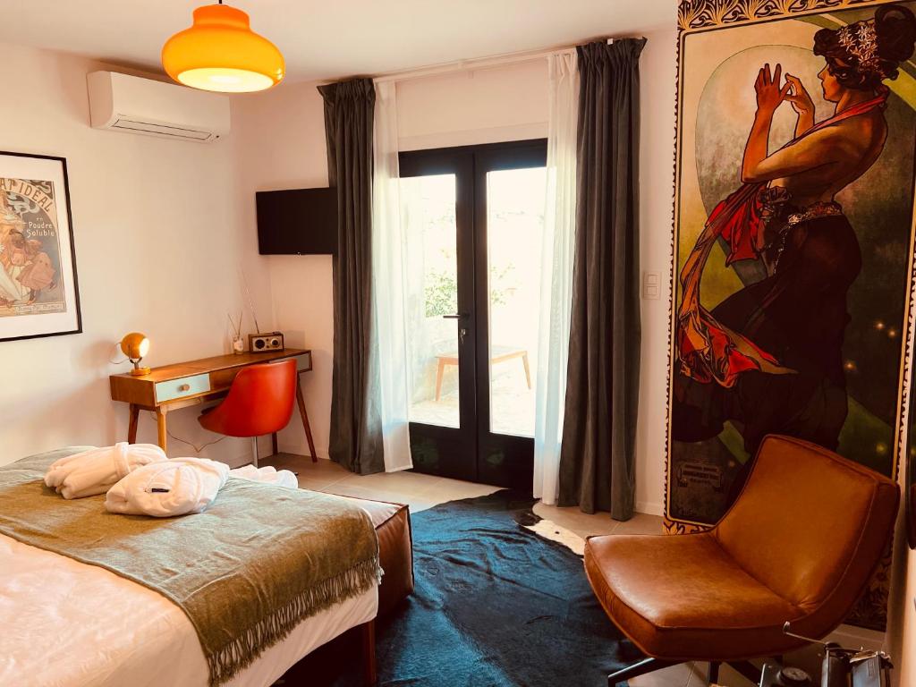 a bedroom with a bed and a chair and a painting at B&B 366 in Vrboska