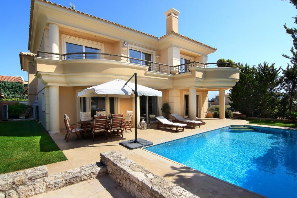 a villa with a swimming pool and a house at Villa Sabia in Vari