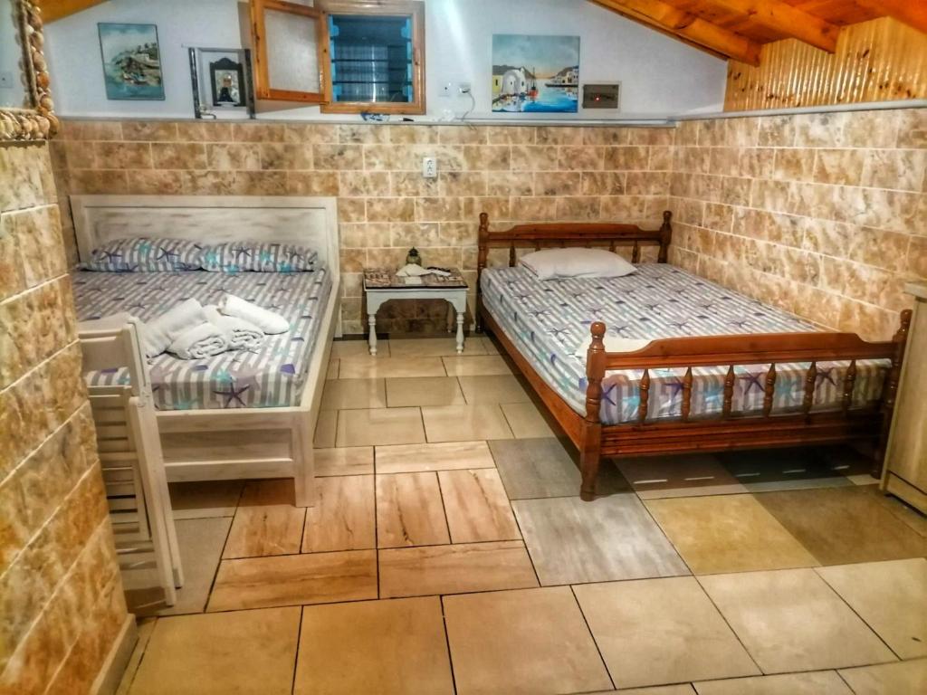 a bedroom with two beds in a room at To Kyma in Skala Kallirakhis
