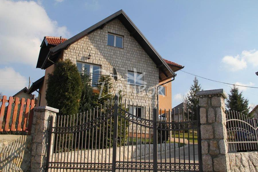 a house with a wrought iron fence in front of it at Vila Pavle in Užice