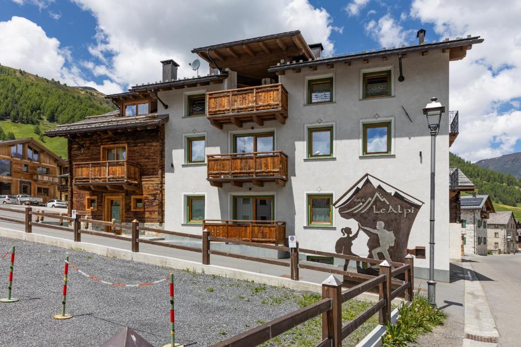 a building with a sign on the side of it at Wood Mountain Planet Suite House in Livigno