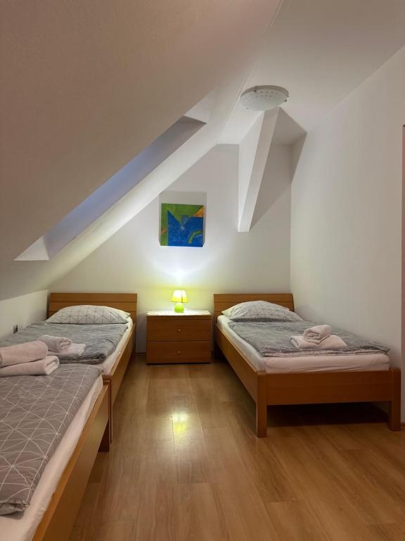 two beds in a room with a attic at Glamping Laško in Laško
