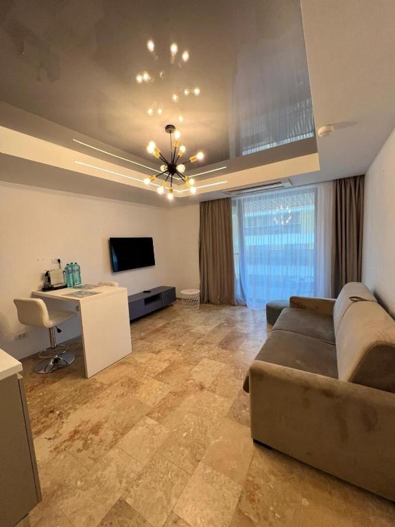 a large living room with a couch and a desk at Apartament Maria Novum Residence in Olimp