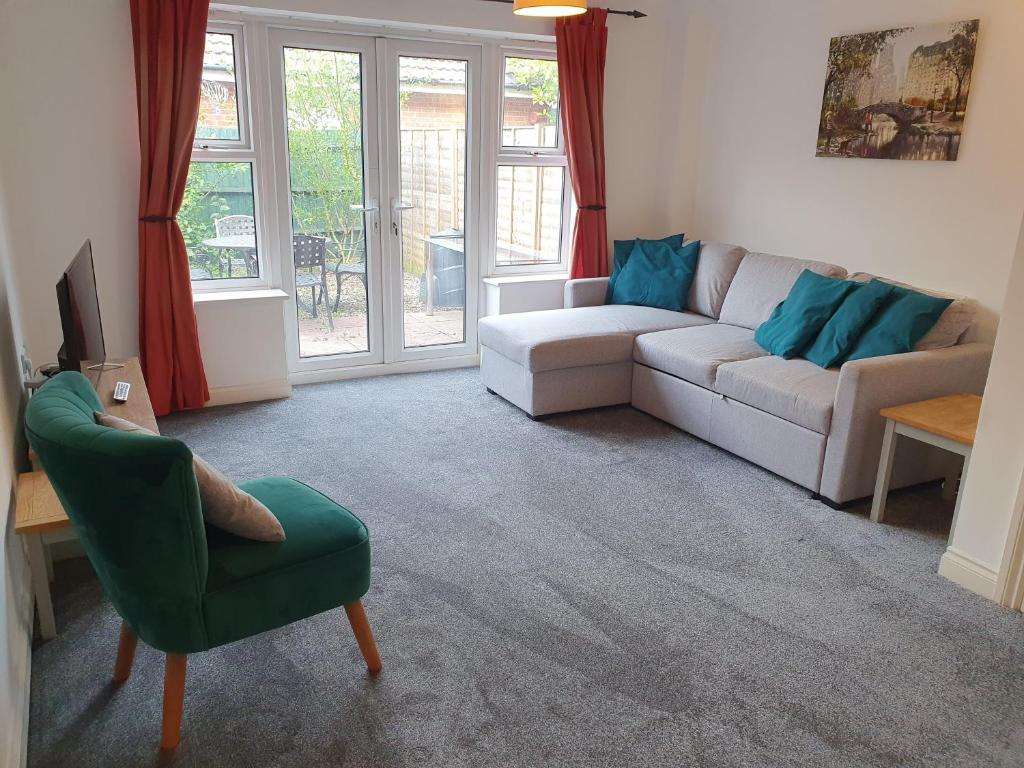 a living room with a couch and a chair at Swindon House by Cliftonvalley Apartments in Swindon