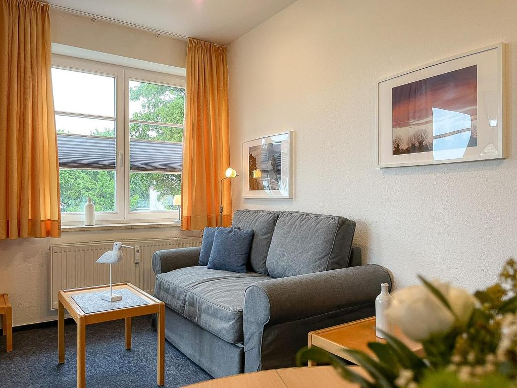 a living room with a couch and a table at Dünenblick Wohnung 24 in Boltenhagen