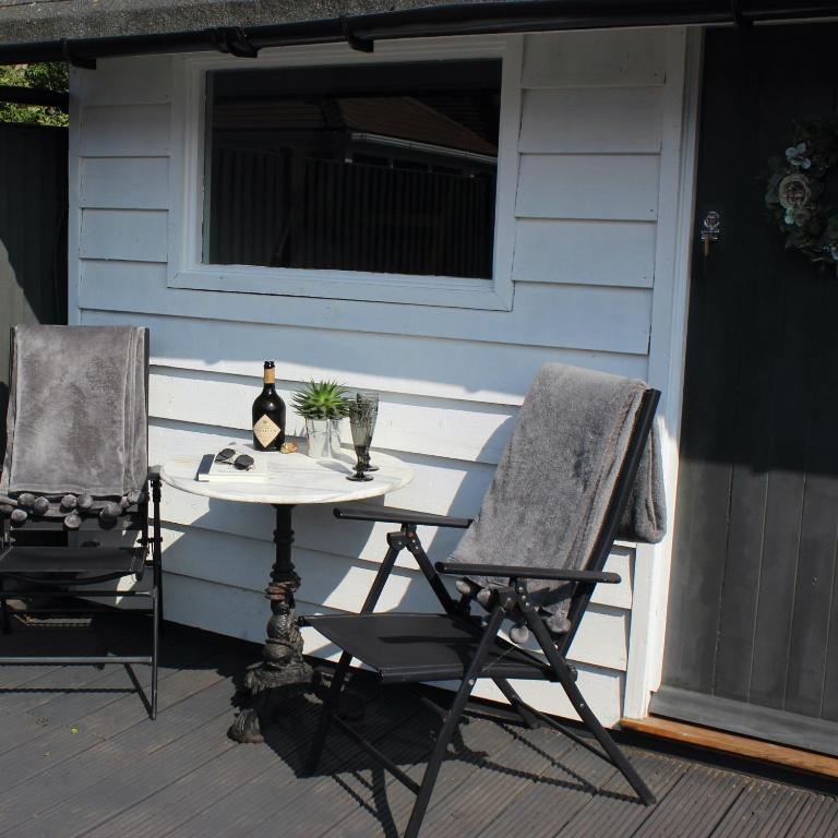 a table and two chairs on a patio at The Bubble Hideaway - A Little Oasis near the Sea in Whitstable