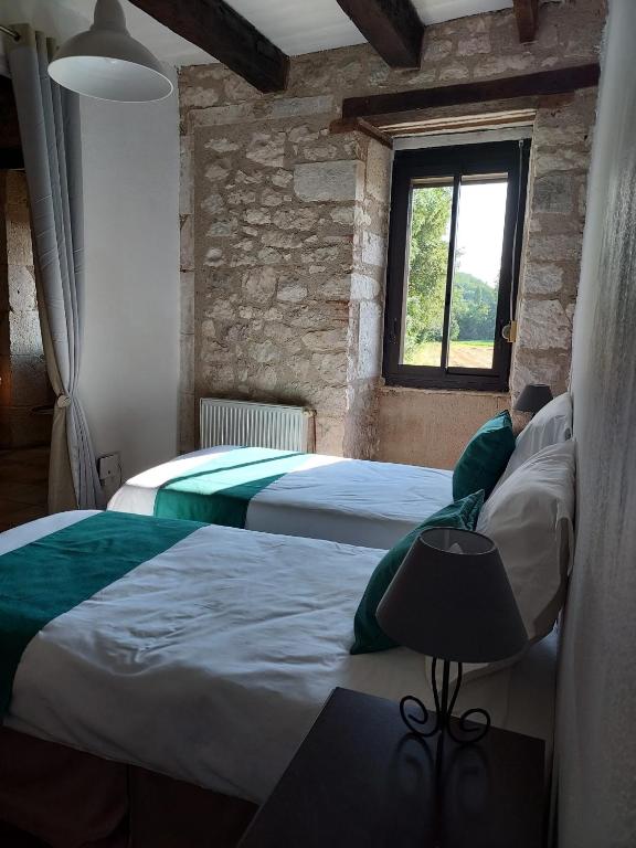 Postel nebo postele na pokoji v ubytování Le Moulin de Bernard