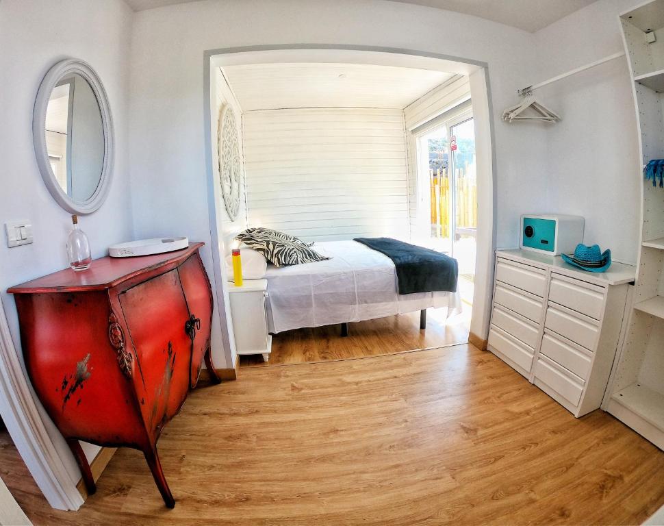 a bedroom with a bed and a mirror and a dresser at FINCA BEROLO 4 in Guía de Isora