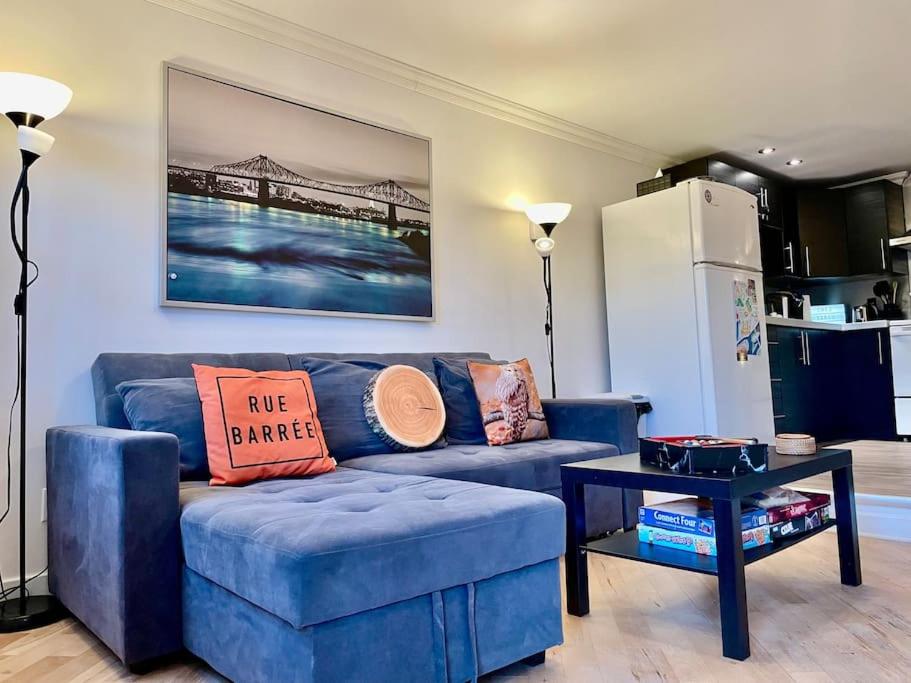 sala de estar con sofá azul y nevera en Chez Sarah: Montreal themed cozy loft, en Montreal