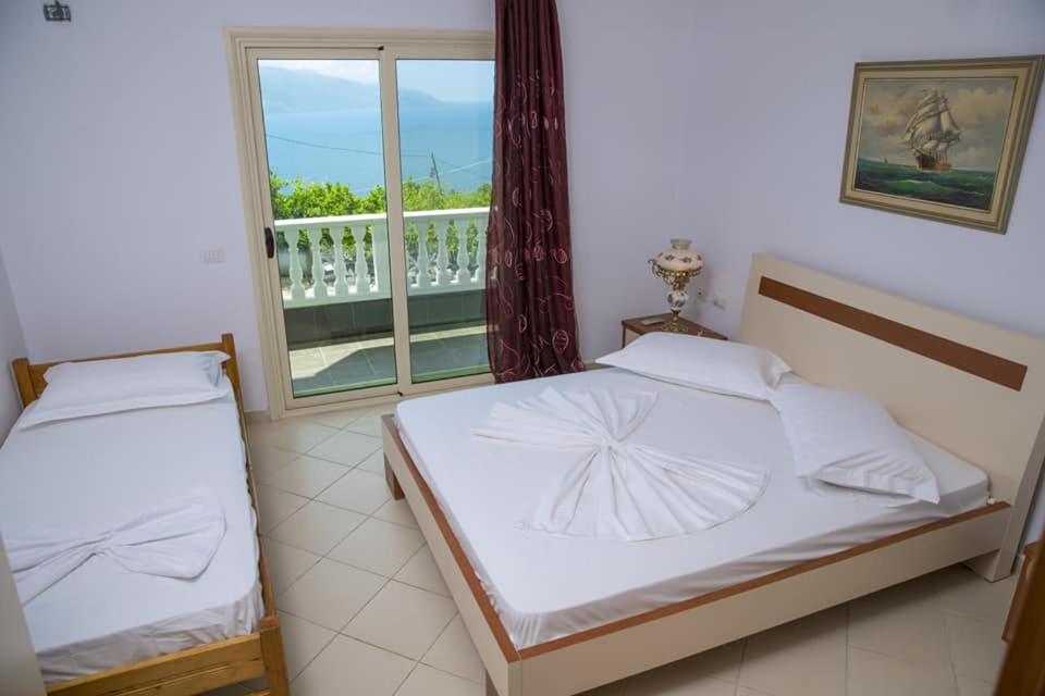 a bedroom with two beds and a window at 360° View Apartments in Vlorë