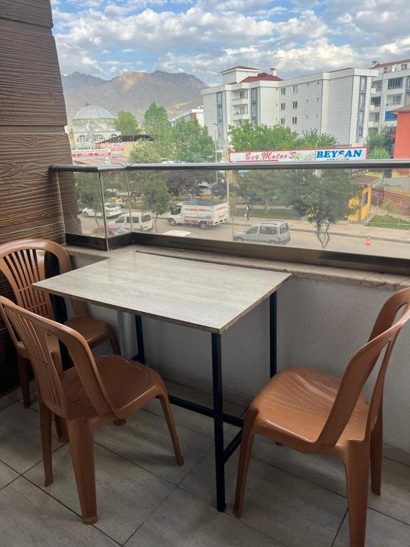 a table and two chairs in front of a window at Comfort house Van in Van