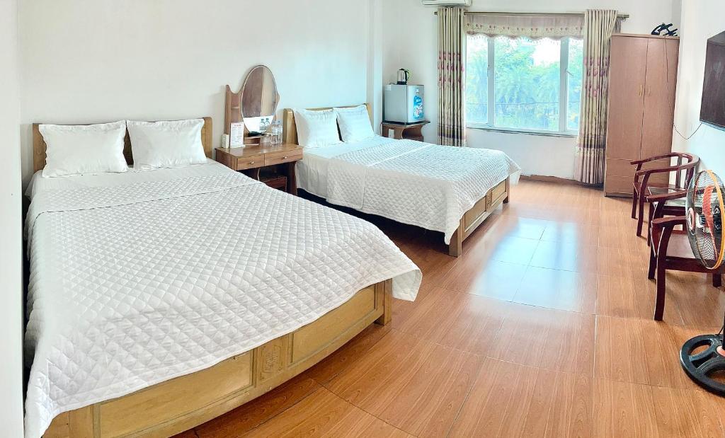 Postel nebo postele na pokoji v ubytování Van Anh Hotel