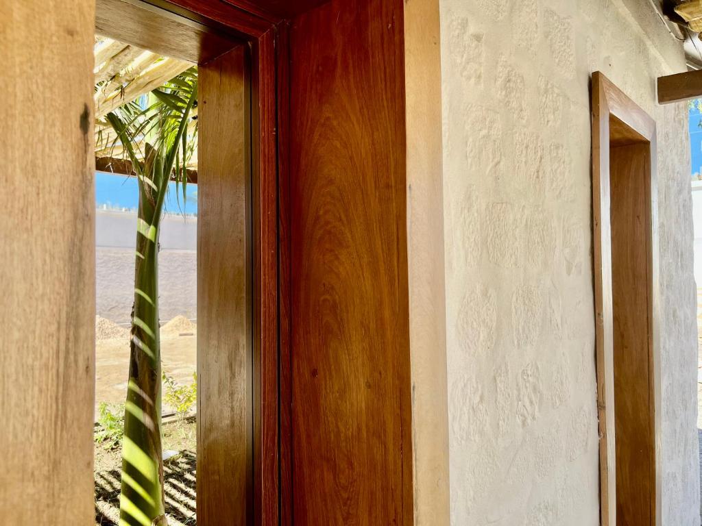 a wooden door with a view of the beach at LE VAHINÉ Eco-RESORT in Toliara