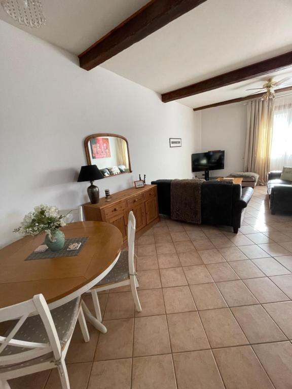 a living room with a table and a couch at Gite d'Ecosse in Azille