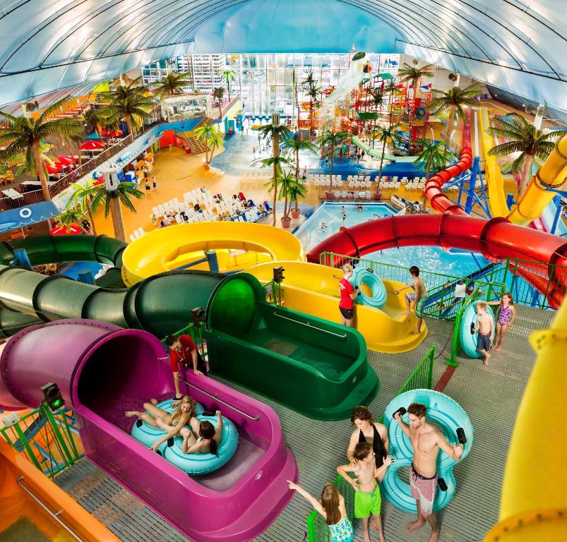 an indoor water park with people playing in it at Skyline Hotel & Waterpark in Niagara Falls