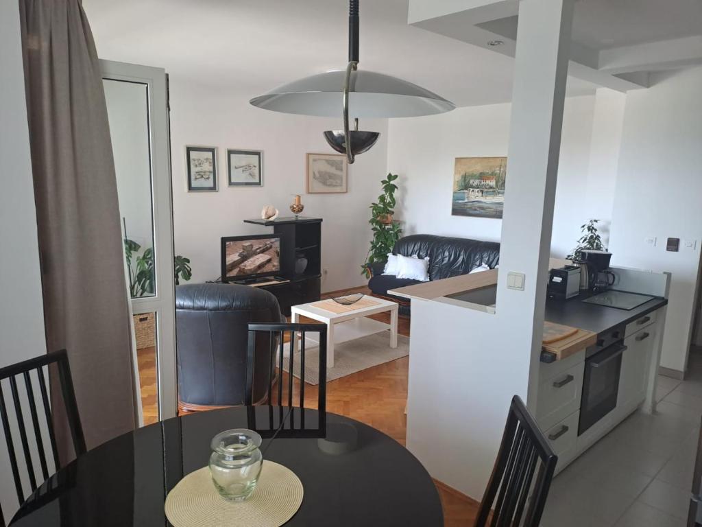 a kitchen and a living room with a table and chairs at City, sea and river view, Omis in Omiš