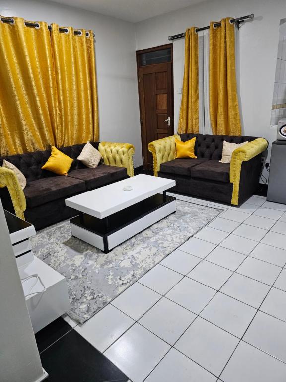 a living room with couches and a coffee table at Luxurious cozy homes Jsb apartment in Mombasa