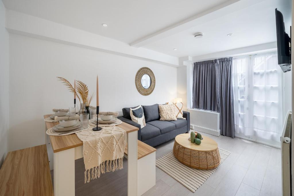 a living room with a couch and a table at Russell Sq Suite - 2 Bed Apartment in London