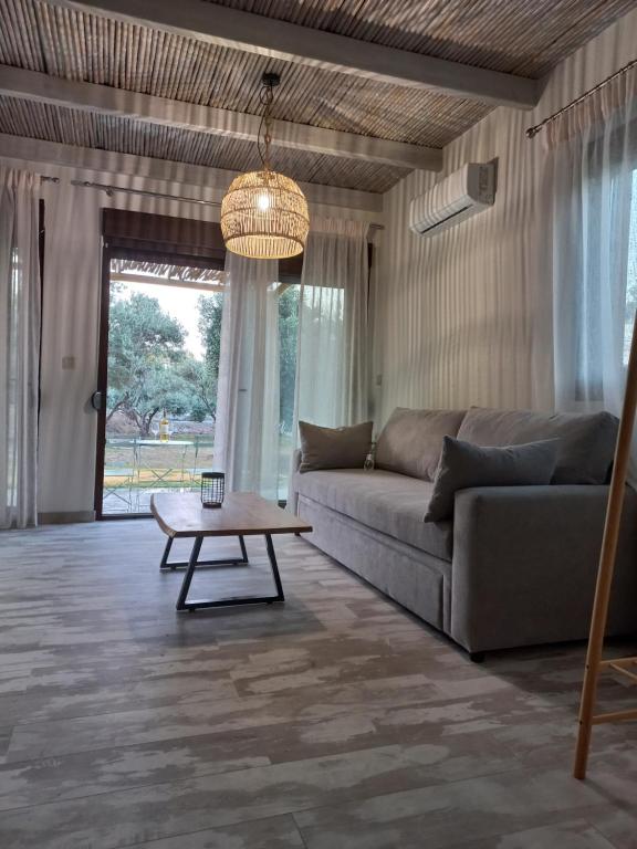 a living room with a couch and a coffee table at Valia's Beach House in Samos