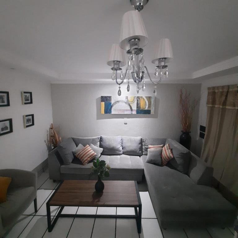 a living room with a couch and a table at Casa Blanca Posadas in Posadas