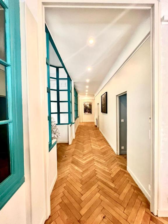 a hallway in a house with wooden floors at Palais Hervé in Cannes