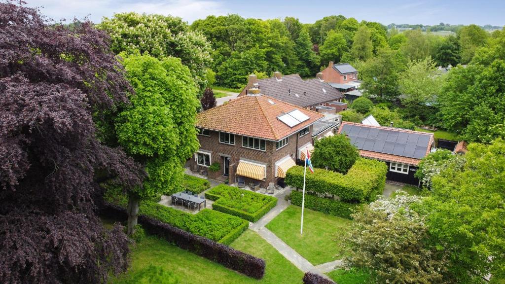 an aerial view of a house with a yard at B&B - Sauna D'Olle Pastorie in Vierhuizen