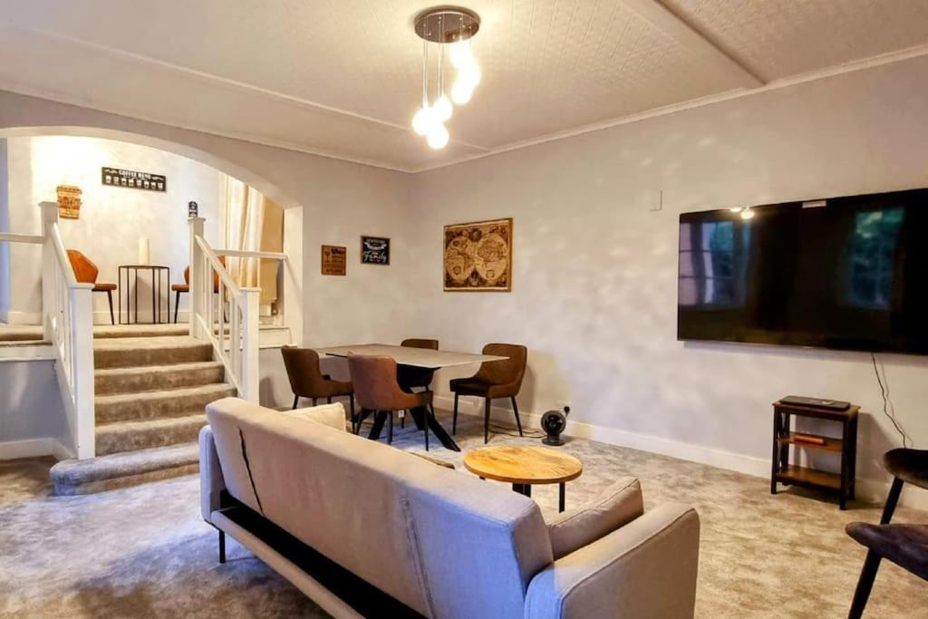 a living room with a couch and a table at Crondall Stores Flat in Crondall