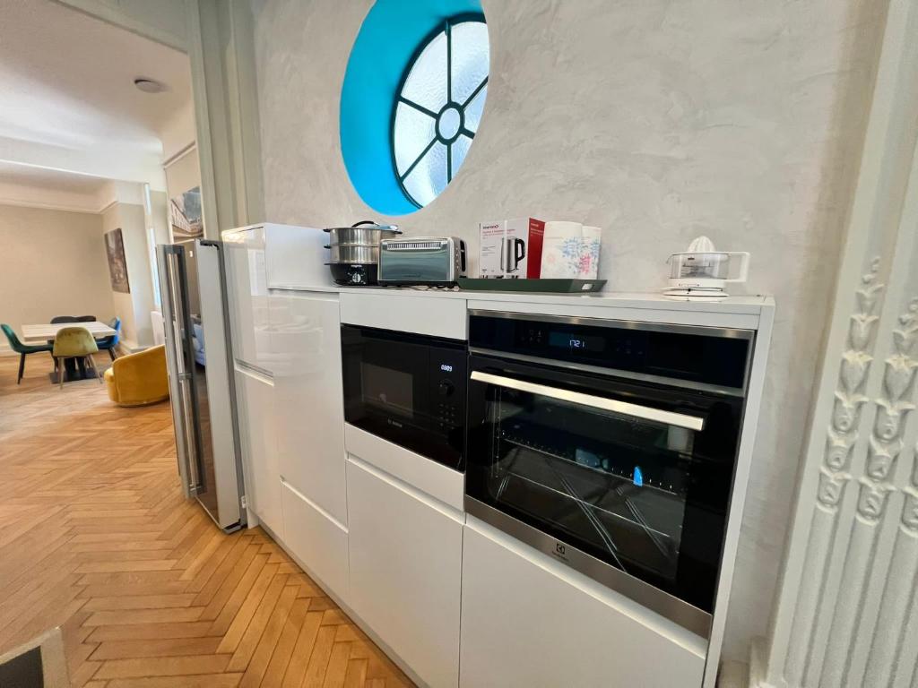 a kitchen with a black oven and a window at Palais Hervé in Cannes