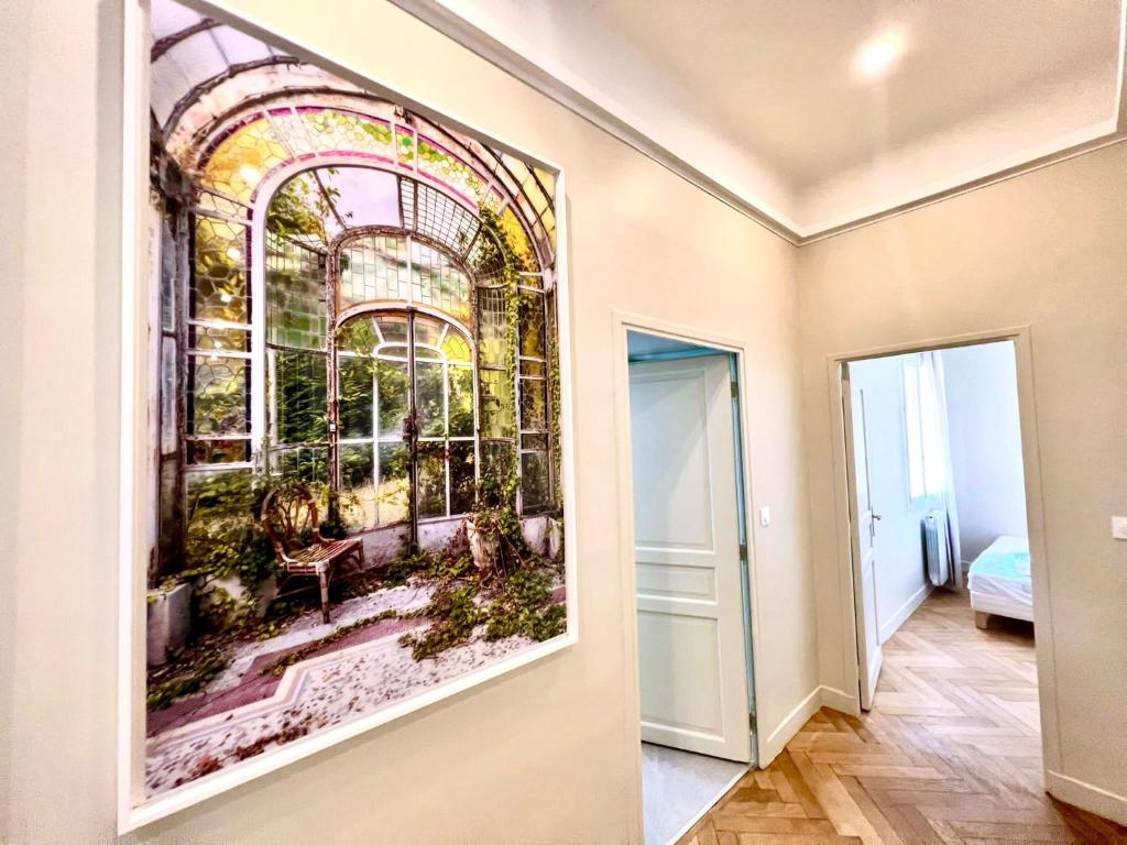 a room with a painting on the wall next to a door at Palais Hervé in Cannes