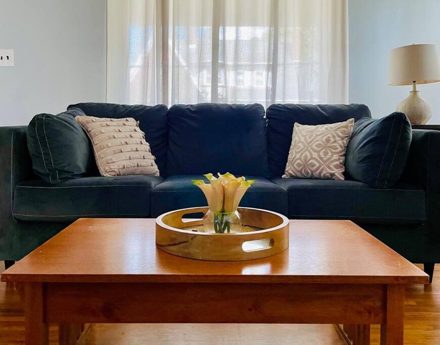 a living room with a blue couch and a coffee table at Green Roof Inn - Centrally Located 2BR/1BA Home in Evansville