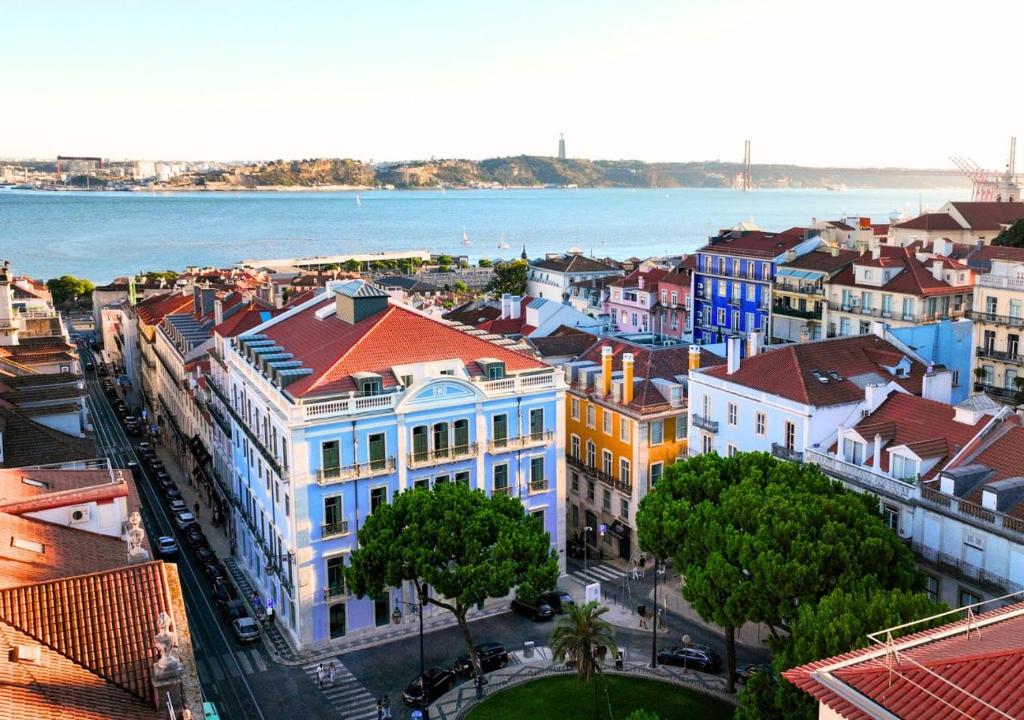 an aerial view of a city with the water at Montebelo Vista Alegre Lisboa Chiado Hotel in Lisbon