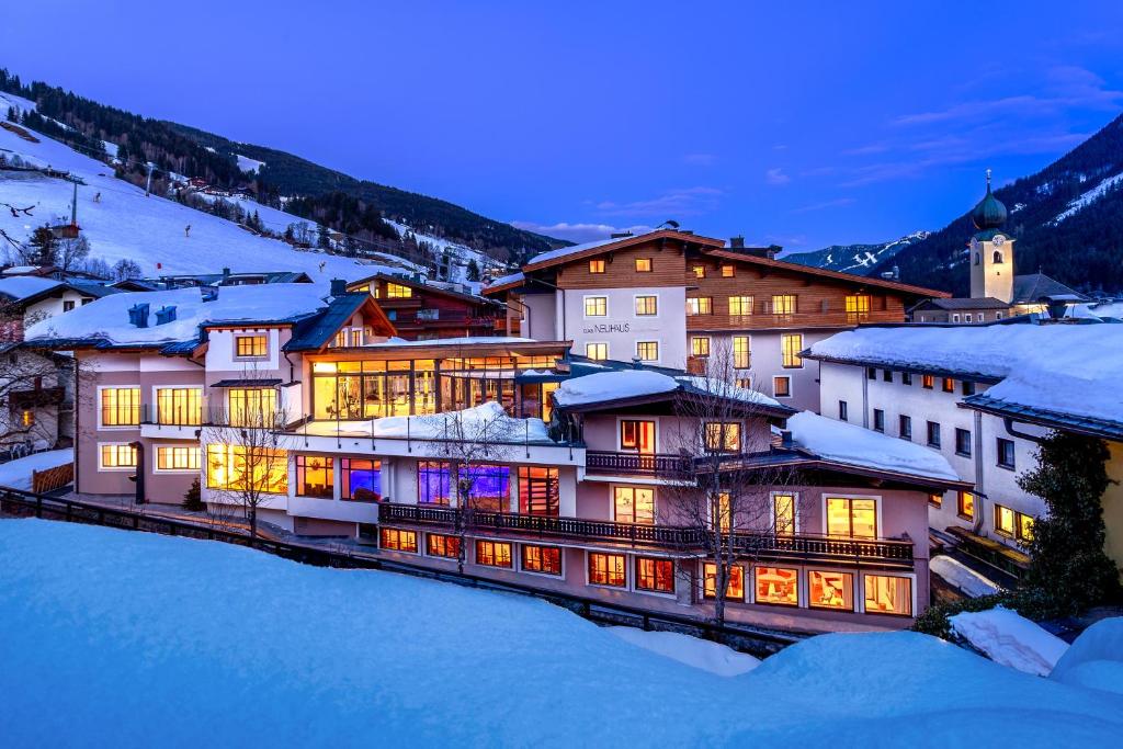 a group of buildings in the snow at night at Hotel Neuhaus in Saalbach-Hinterglemm