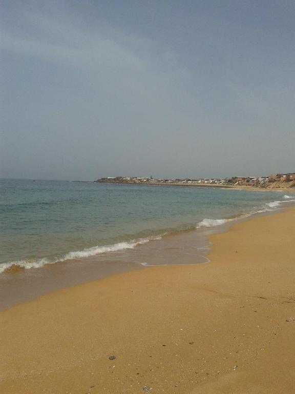 a sandy beach with the ocean in the background at Bahia beach . Plage dahomey in Bouznika