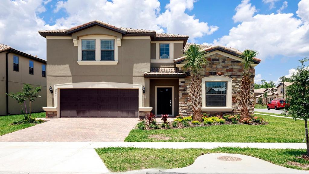 a house with a garage in a residential neighborhood at Windsor At Westside Superpower 8801 in Kissimmee