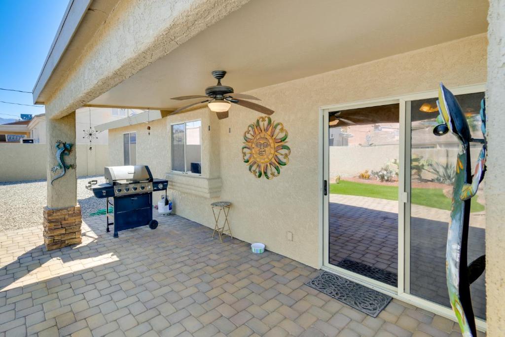 a patio with a ceiling fan and a grill at Pet-Friendly Arizona Abode Near Beaches and Golfing! in Lake Havasu City