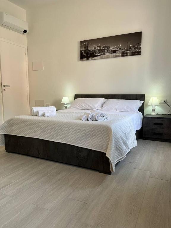 1 dormitorio con 1 cama grande y 2 toallas. en Central Rooms Posada, en Posada