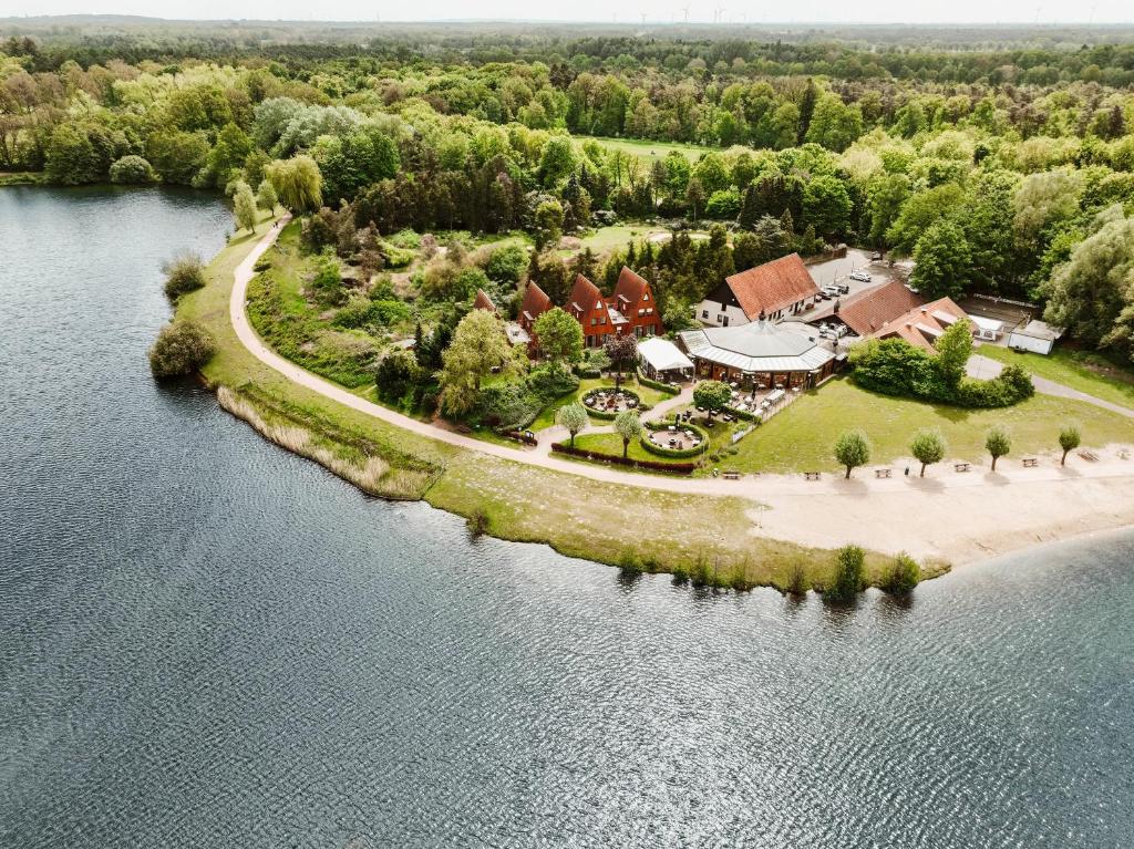 an aerial view of a house on an island in the water at Appartementhotel Seeblick in Gronau