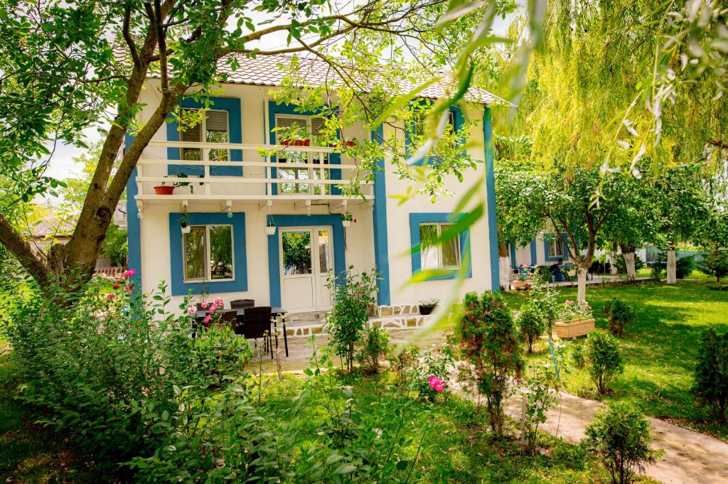 a blue and white house with a garden at Pescarul Deltei in Murighiol