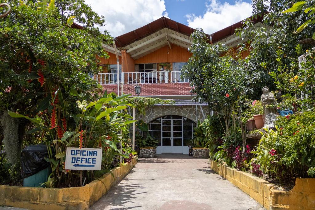 a house with a sign in front of it at Hotel & Restaurante Hanna Resort in Panajachel