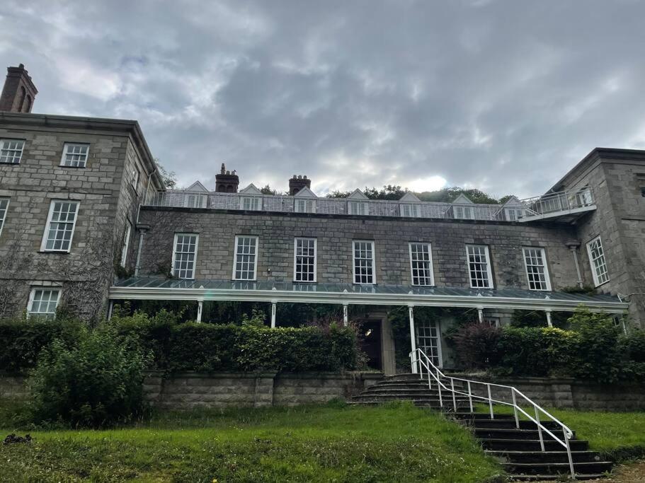 a large brick building with stairs in front of it at Marle Hall - Dorm Rooms (Blue) in Llandudno Junction