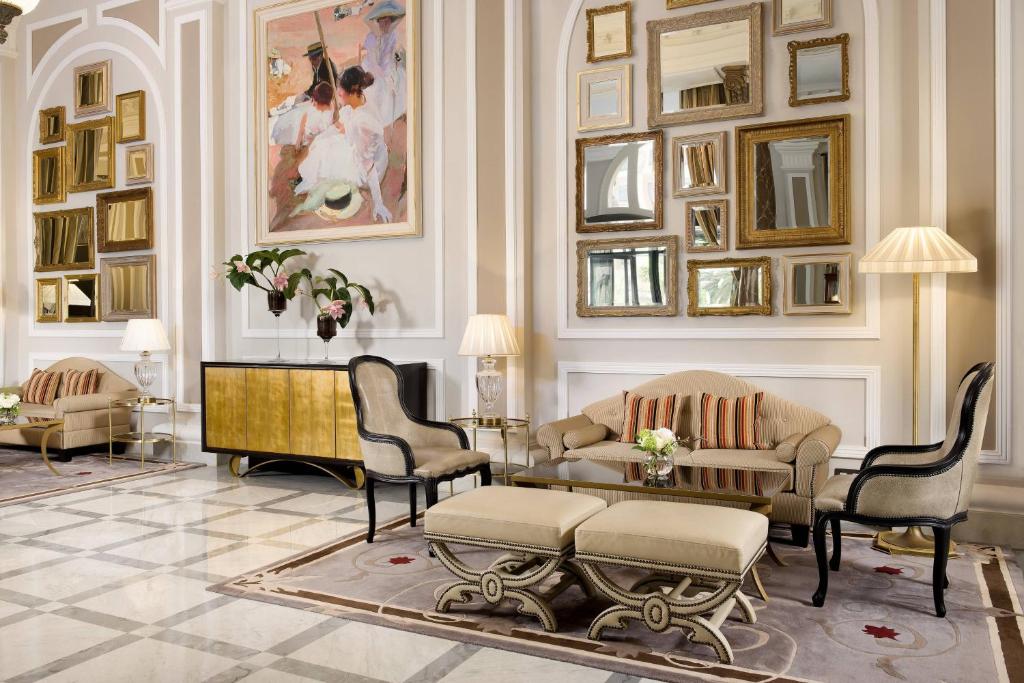 a living room with chairs and a table at Hotel Maria Cristina, a Luxury Collection Hotel, San Sebastian in Donostia-San Sebastián