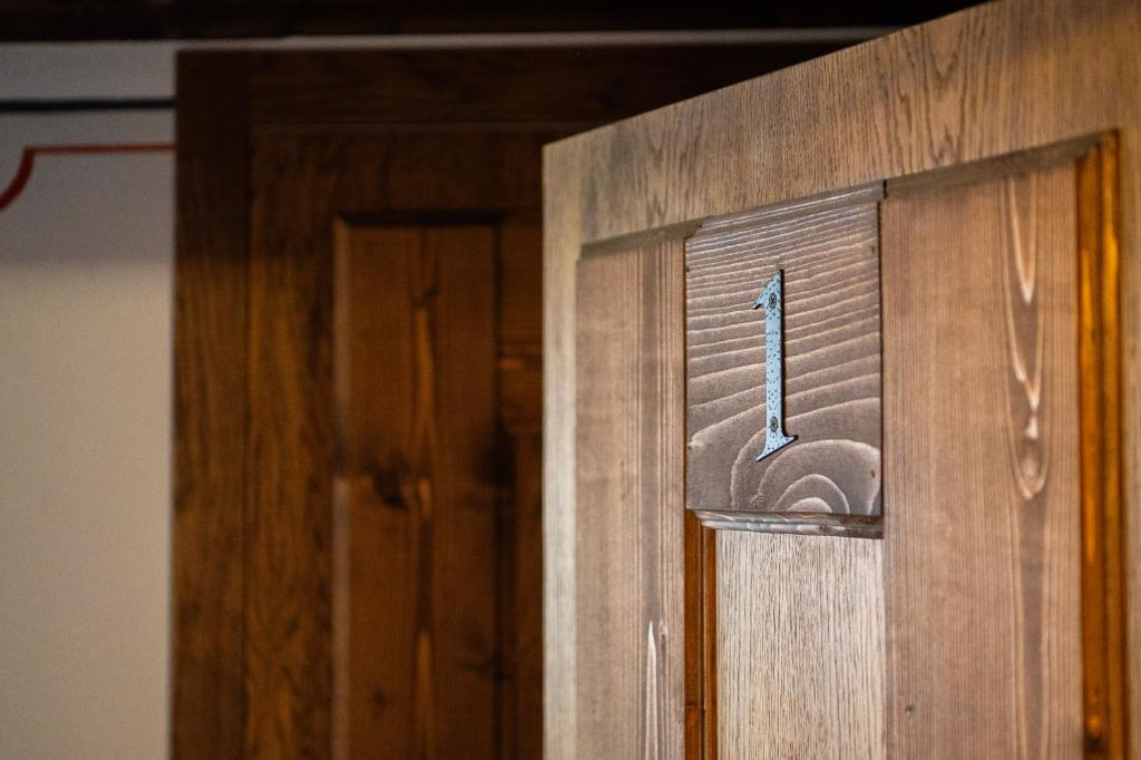 a wooden door with a metal handle on it at Къща ЕТНО in Koprivshtitsa