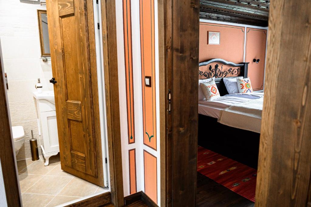 a bedroom with a bed in a room with a door at Къща ЕТНО in Koprivshtitsa