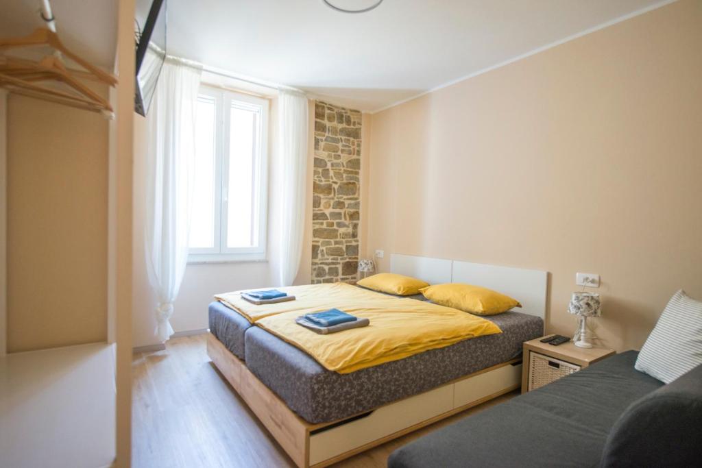 a bedroom with two beds and a window at Apartments E & E Piran in Piran